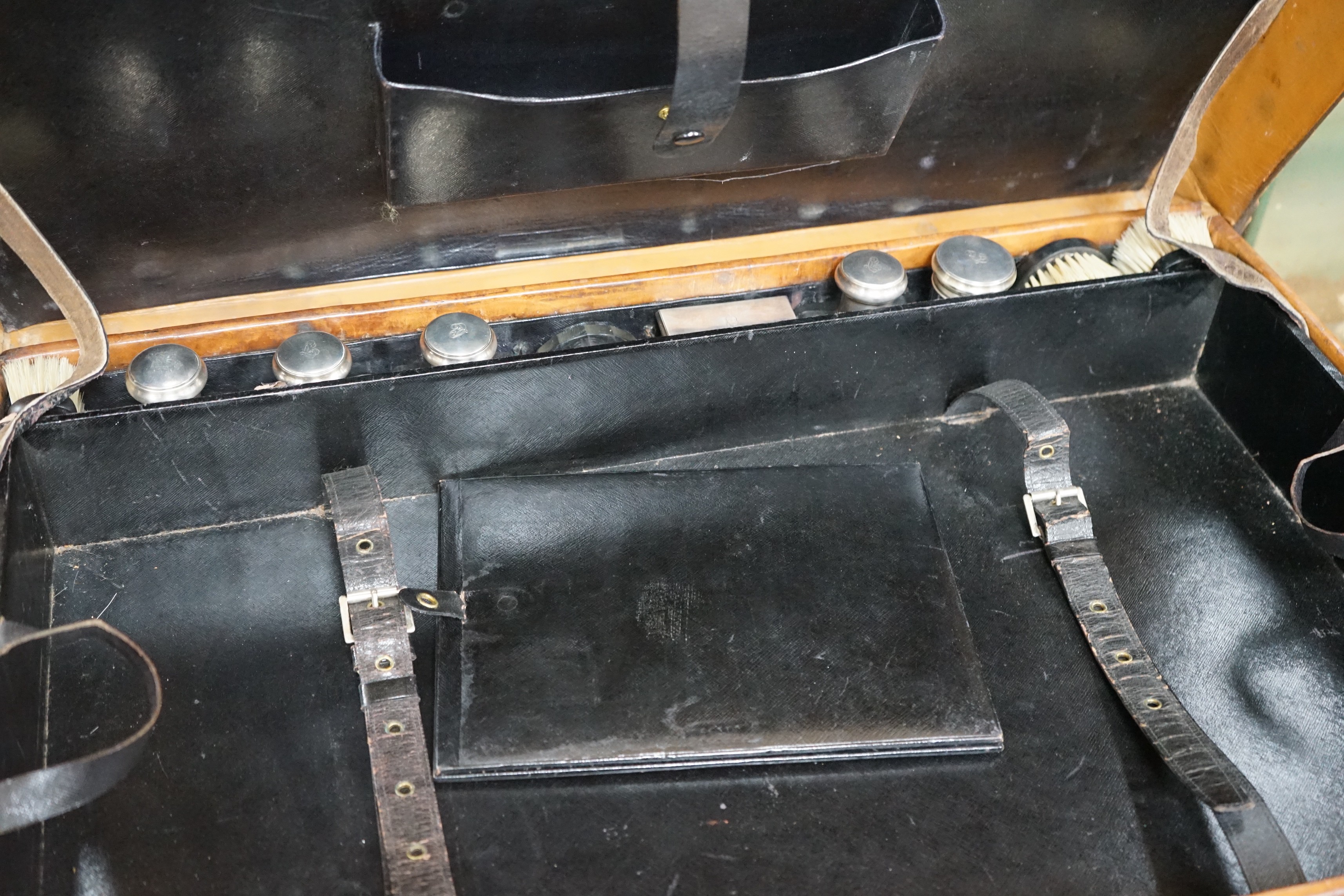 A Dupont travel suitcase, initialled ‘L.C.’ with French white metal mounted bottles
